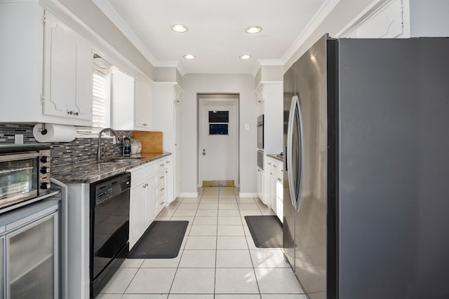 kitchen featuring black dishwasher, light tile patterned flooring, dark stone countertops, stainless steel fridge, and white cabinets