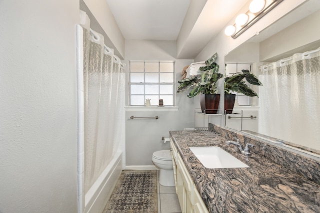 full bathroom featuring tile patterned floors, vanity, shower / bath combination with curtain, and toilet