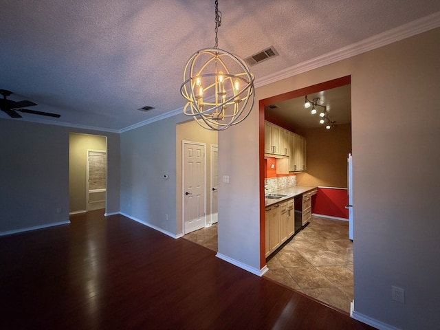 interior space featuring wood-type flooring, black dishwasher, a textured ceiling, and crown molding