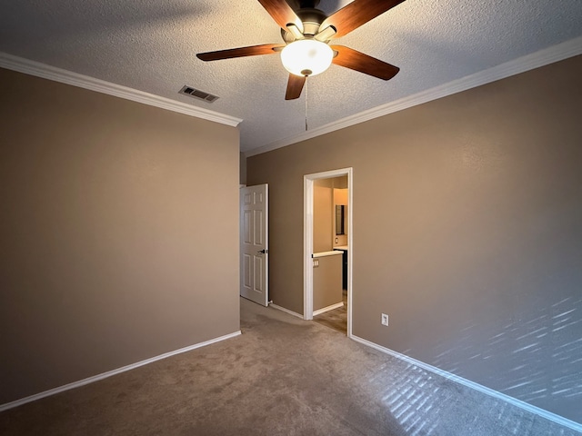 unfurnished bedroom with ensuite bathroom, carpet floors, ornamental molding, ceiling fan, and a textured ceiling