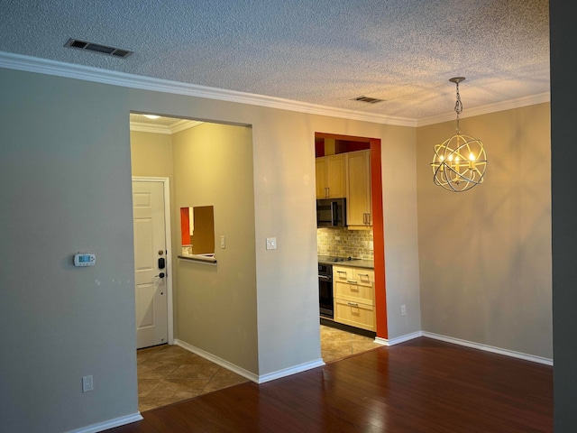 interior space featuring ornamental molding, a chandelier, and light hardwood / wood-style flooring