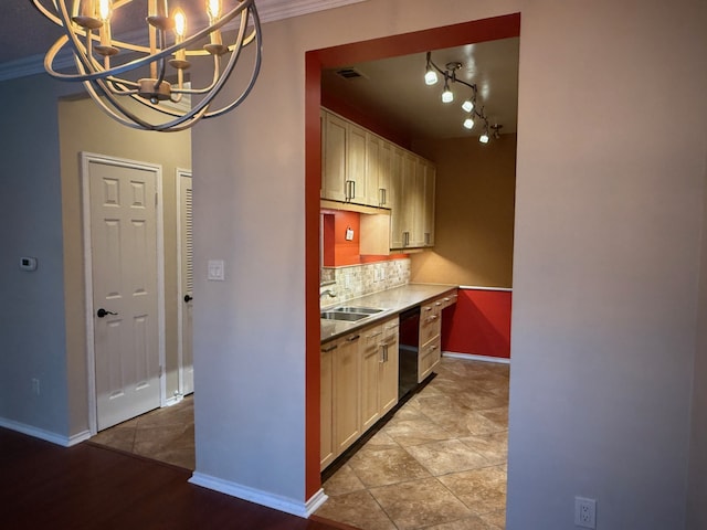 kitchen featuring decorative light fixtures, black dishwasher, sink, decorative backsplash, and ornamental molding