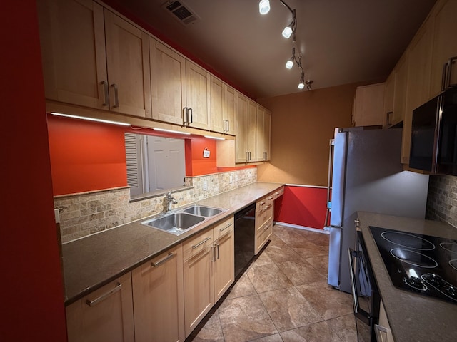 kitchen featuring sink, backsplash, black appliances, and light tile patterned floors