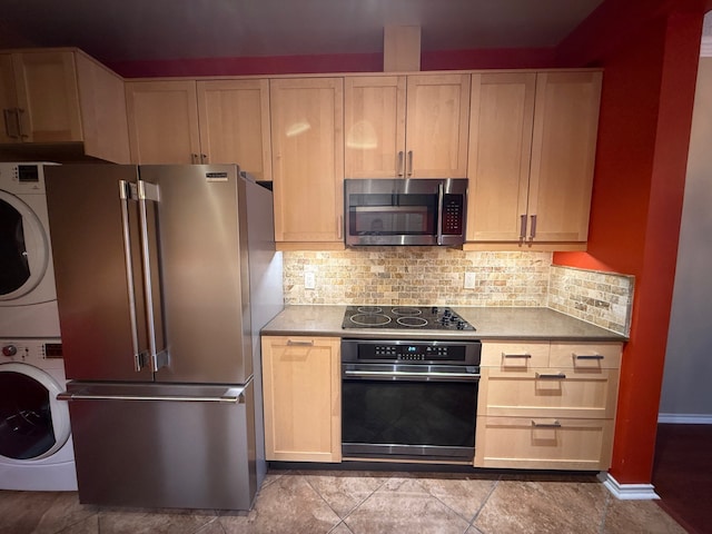 kitchen with stacked washer and dryer, tasteful backsplash, light brown cabinetry, and black appliances