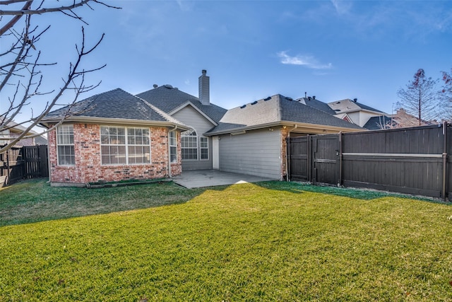 back of property with a yard and a patio