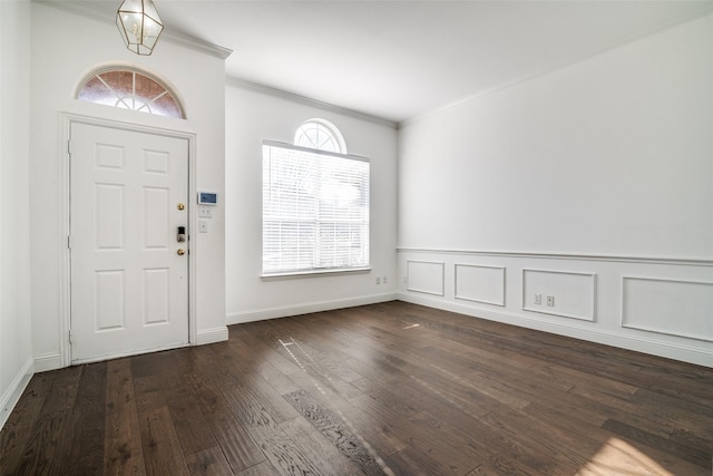 entryway with crown molding, a healthy amount of sunlight, and dark hardwood / wood-style flooring