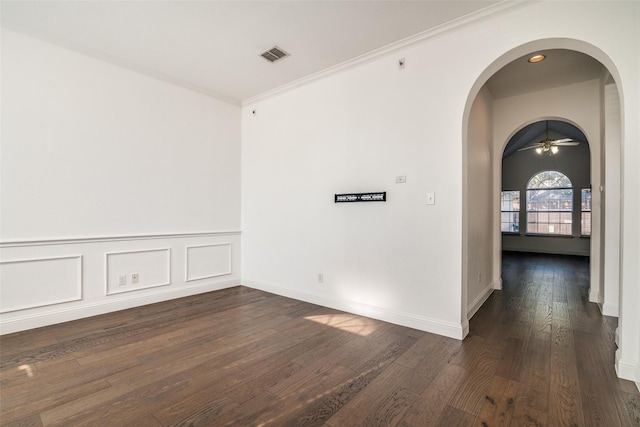 unfurnished room featuring crown molding, dark hardwood / wood-style floors, and ceiling fan