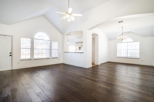 unfurnished living room with high vaulted ceiling, ceiling fan with notable chandelier, and dark hardwood / wood-style flooring