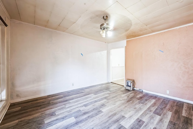 spare room featuring hardwood / wood-style flooring, crown molding, and ceiling fan