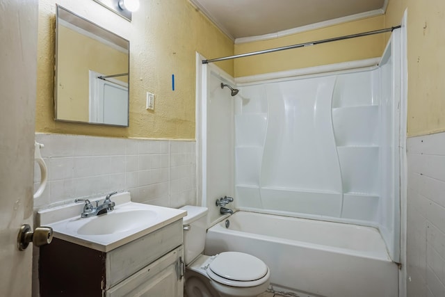 full bathroom with shower / bath combination, vanity, tile walls, and toilet