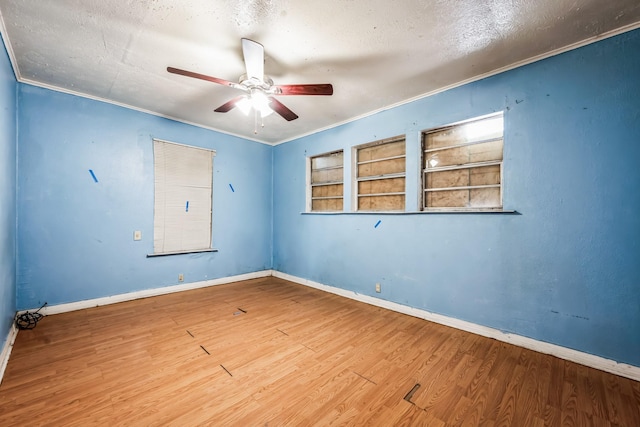 unfurnished room with ceiling fan, ornamental molding, hardwood / wood-style floors, and a textured ceiling