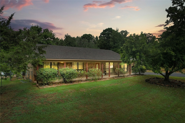 single story home featuring a patio and a lawn