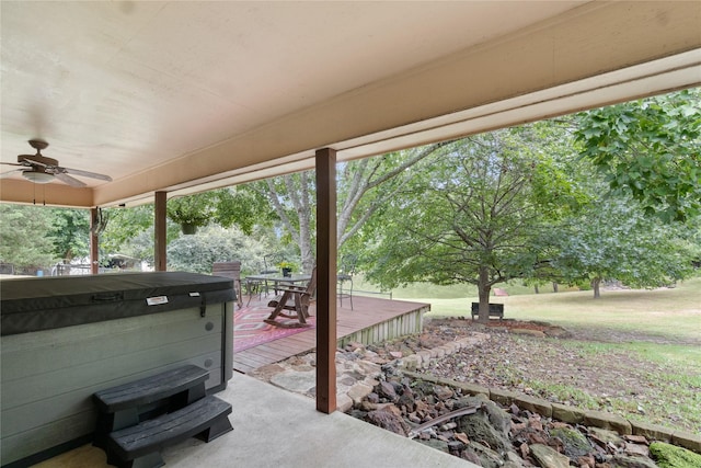 view of patio featuring a hot tub, a wooden deck, and ceiling fan