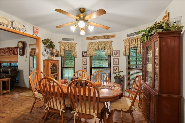 dining area with hardwood / wood-style flooring and ceiling fan