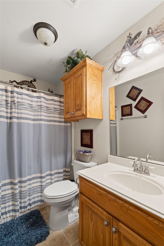 bathroom with tile patterned floors, vanity, and toilet