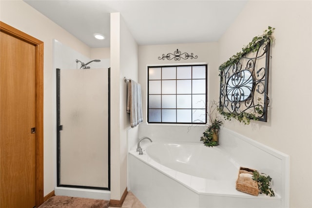 bathroom featuring tile patterned floors and separate shower and tub