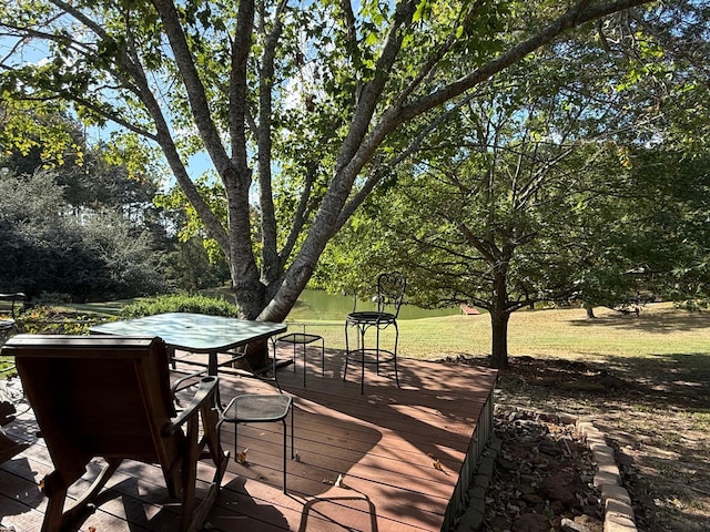 wooden deck featuring a lawn