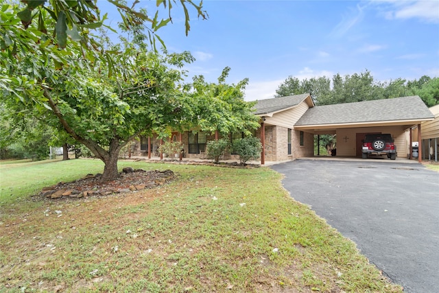 view of front of house with a front yard and a carport