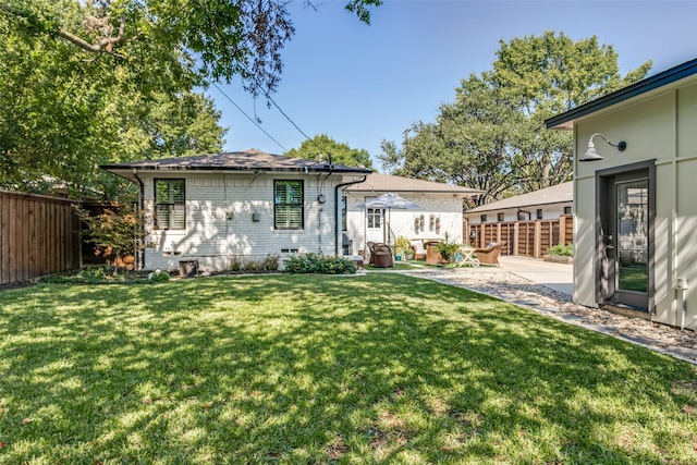 rear view of property with a patio area and a yard