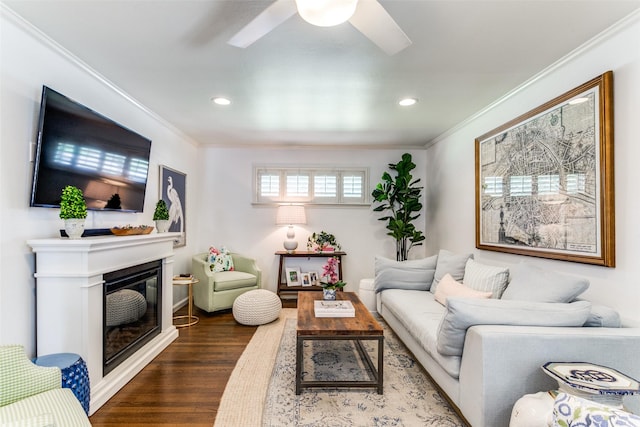 living room with ceiling fan, wood-type flooring, and crown molding