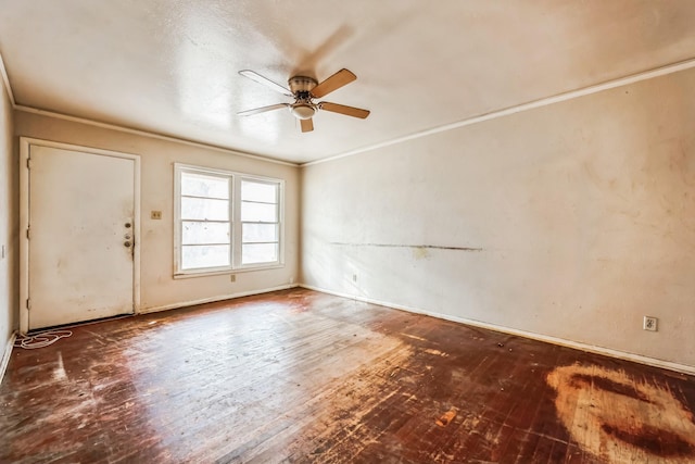 spare room featuring crown molding, ceiling fan, and dark wood-type flooring