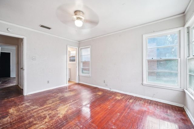 empty room featuring dark hardwood / wood-style floors, ceiling fan, and ornamental molding