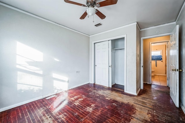 unfurnished bedroom featuring a closet, ceiling fan, crown molding, and dark hardwood / wood-style floors