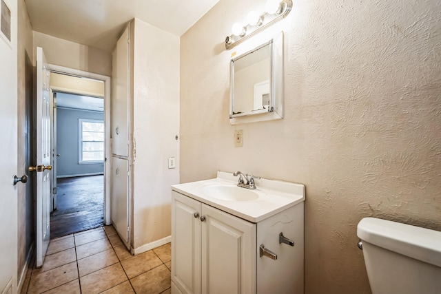 bathroom with tile patterned floors, vanity, and toilet