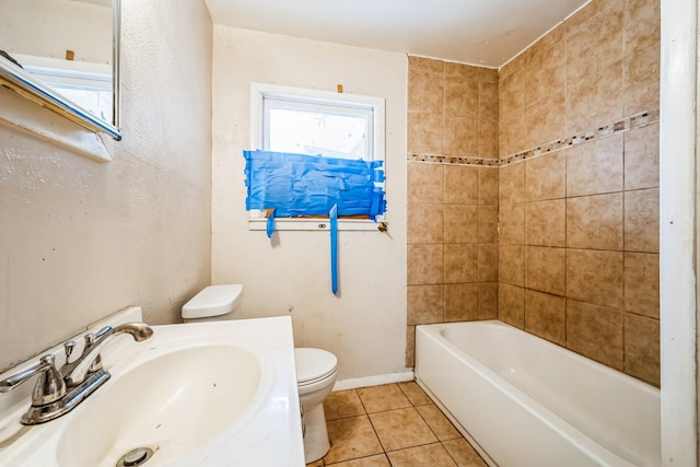 full bathroom with toilet, sink, tiled shower / bath combo, and tile patterned flooring