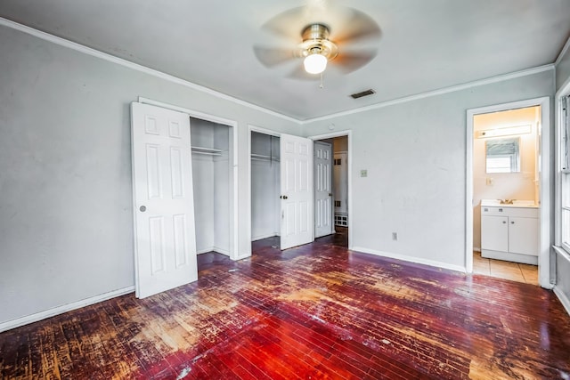 unfurnished bedroom with ceiling fan, wood-type flooring, ornamental molding, and ensuite bath