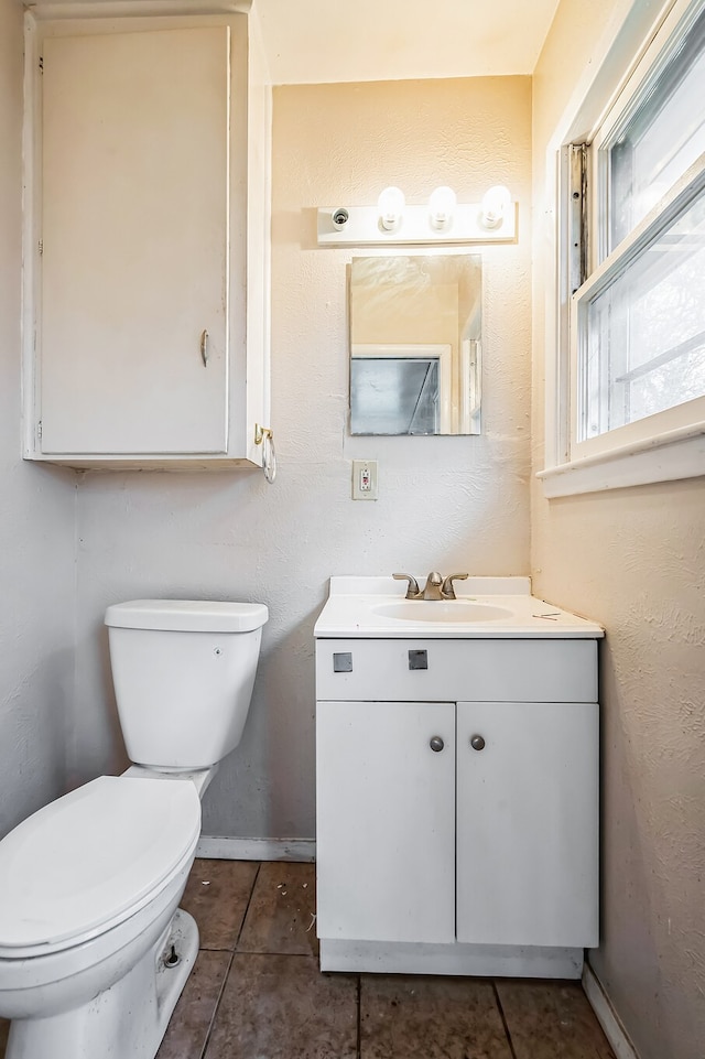 bathroom featuring tile patterned floors, vanity, and toilet