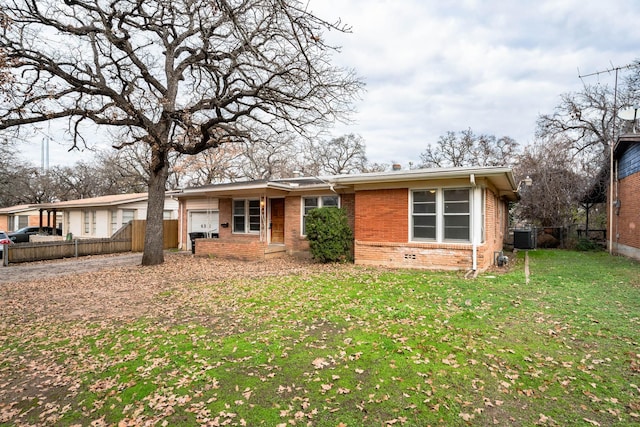 ranch-style home featuring a front yard and central AC