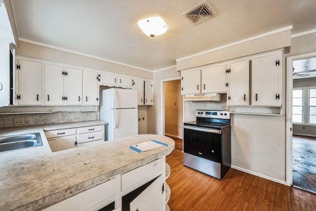 kitchen with white cabinetry, stainless steel electric range oven, sink, white refrigerator, and crown molding