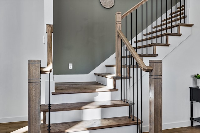 stairway with hardwood / wood-style flooring