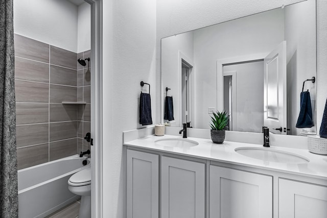 full bathroom featuring vanity, toilet, and shower / tub combo