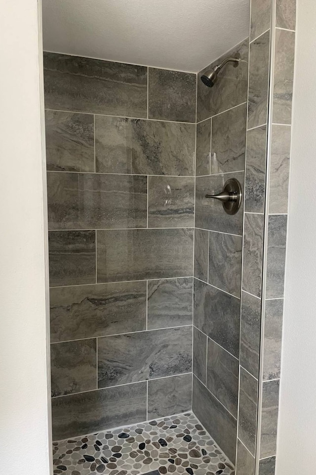 bathroom with tiled shower