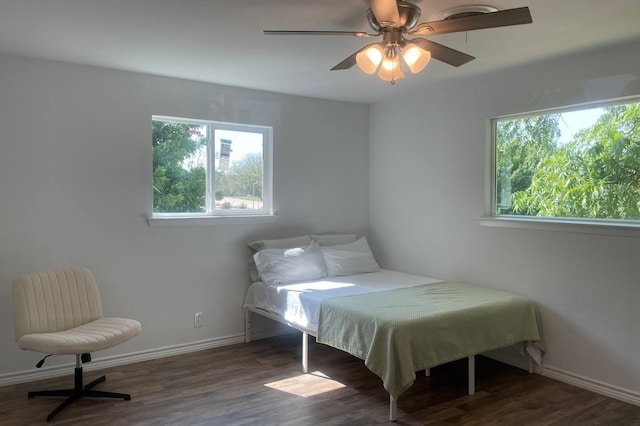 bedroom with ceiling fan and dark hardwood / wood-style flooring