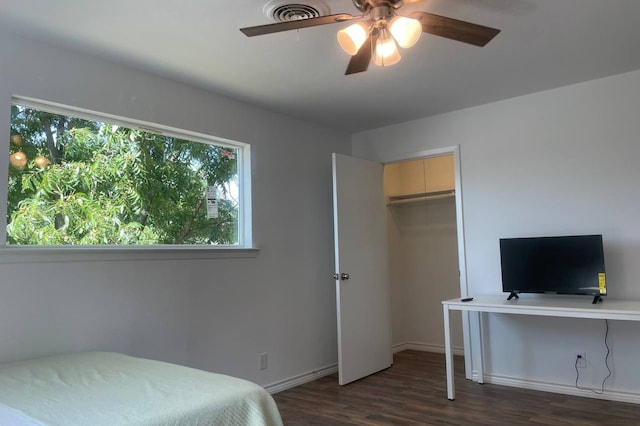 bedroom featuring a closet, ceiling fan, and dark hardwood / wood-style flooring