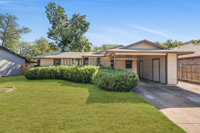 single story home featuring a front lawn and a carport