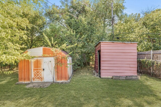 view of outbuilding with a yard