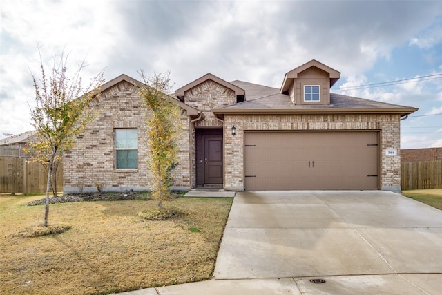 view of front of home featuring a garage and a front lawn