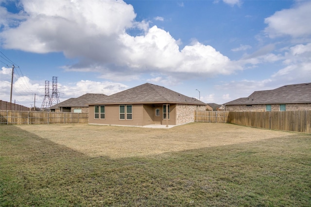 rear view of property featuring a yard