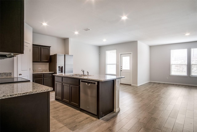 kitchen featuring appliances with stainless steel finishes, a kitchen island with sink, a healthy amount of sunlight, and sink