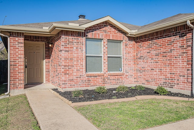 entrance to property with a yard