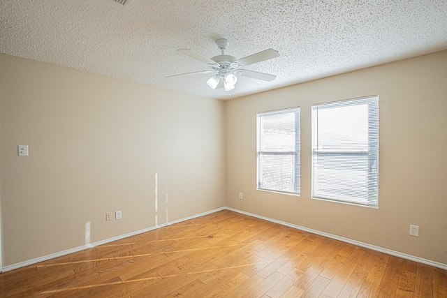 unfurnished room featuring ceiling fan, a textured ceiling, and hardwood / wood-style flooring