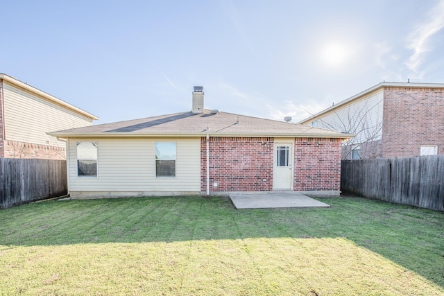 back of house featuring a patio area and a lawn