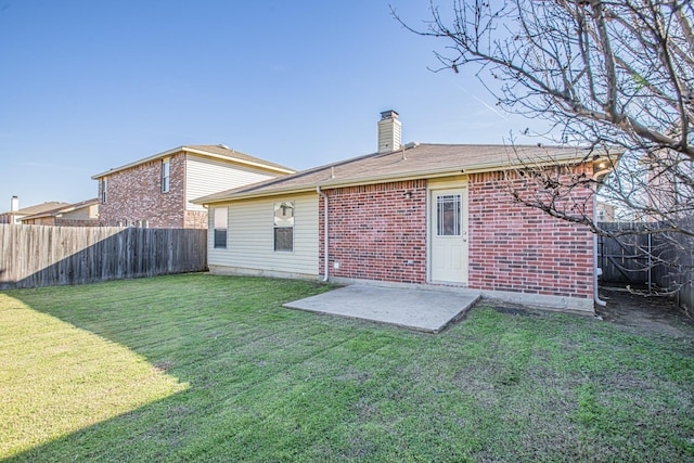 back of house featuring a yard and a patio area