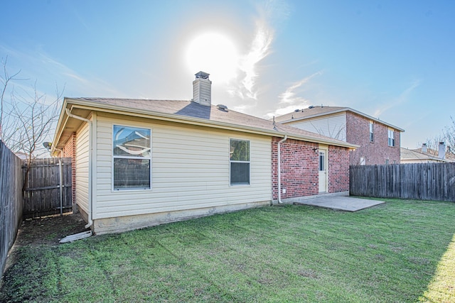 back of property featuring a patio area and a lawn