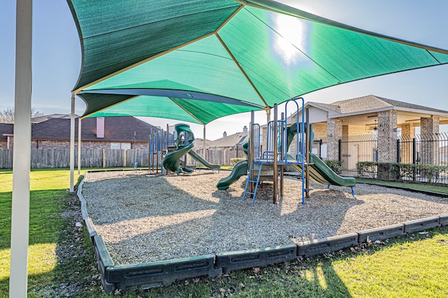 view of playground with a lawn