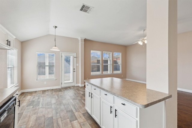 kitchen featuring pendant lighting, dishwasher, white cabinetry, and light hardwood / wood-style flooring